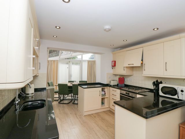 A kitchen with appliances and seating area at Swirl Howe in Keswick