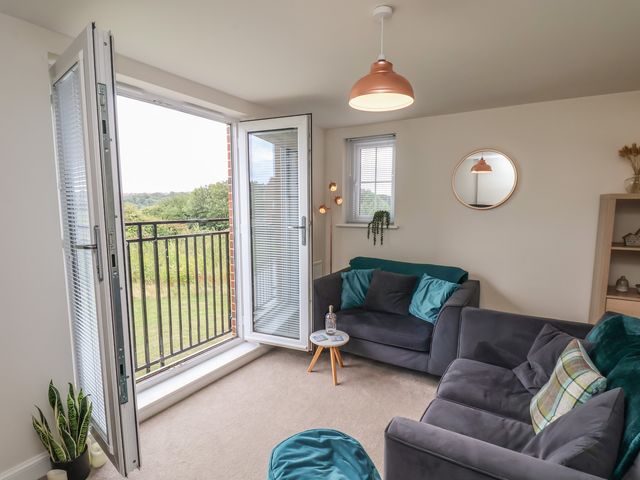 A living room with a balcony and sofa at Larpool Retreat in 