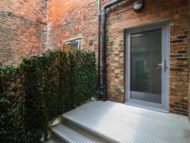 An outdoor area with a door and plant cover at Apartment 10 in York