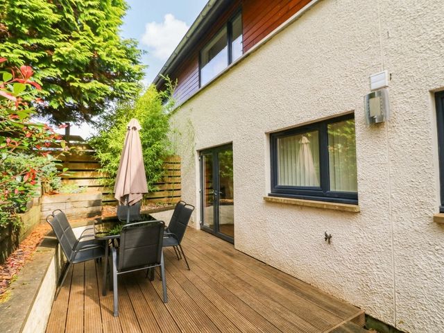 A patio area with a table and chairs at 1 Balnakeil in Dunbeg