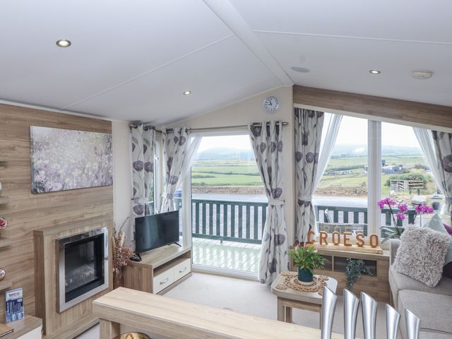 A living room with a television and a view at Bryncrin in Edern