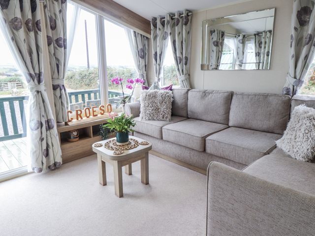 A living room with a sofa and a table at Bryncrin in Edern