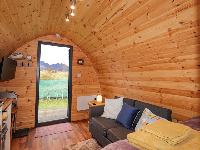 A living room with a sofa and television at The Pod at Greenbank Isle of Skye