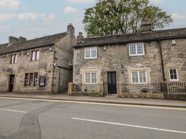 A stone house with windows and door at The Toll Bar in Hope Valley
