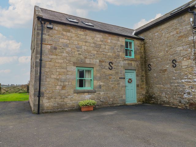 A stone exterior of a building with a door and window at The Annex 