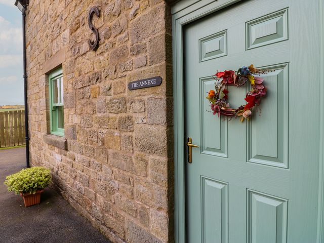 A green front door with a wreath at The Annex