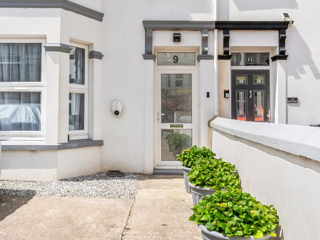 An entrance with a door and planters at The Sundial St Austell