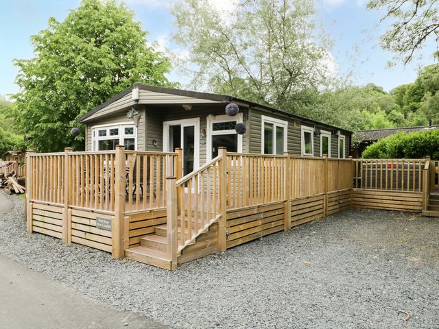 A lodge with a deck and stairs at Owls Nook Lodge, Langdale 9, White Cross Bay near Windermere