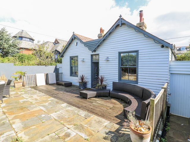 A garden with a deck and furniture at 14 Marine Terrace in Whitstable