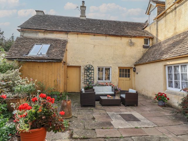 An outdoor seating area with plants and furniture at The Old Dairy in Acton Turville near Nettleton