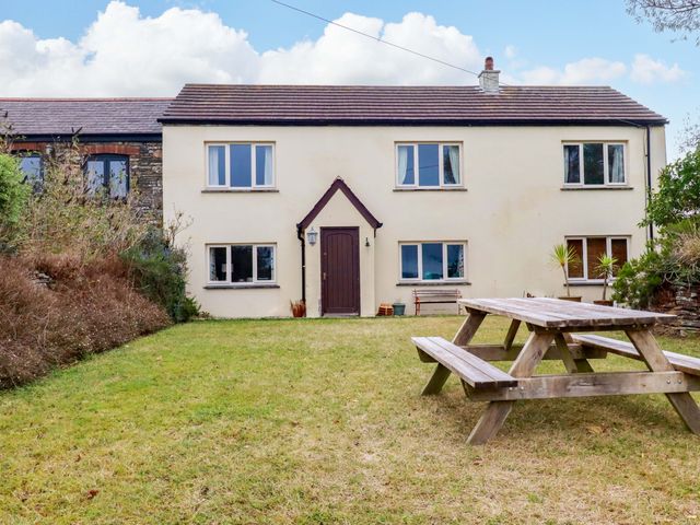 A house with a garden and picnic table at Rosewin Farmhouse near St Minver