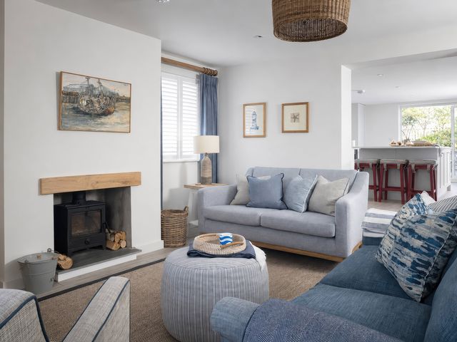 A living room with a sofa and artwork at Wood Cottage