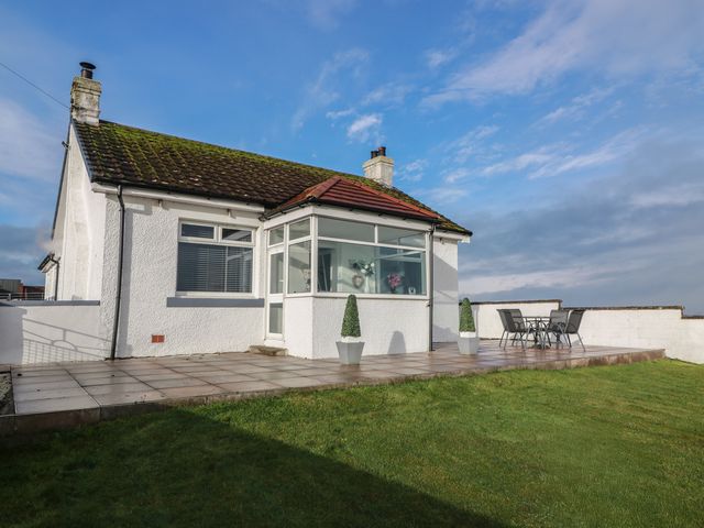A house with a deck and outdoor seating at Marchdyke Farm Cottage Dalton near Annan