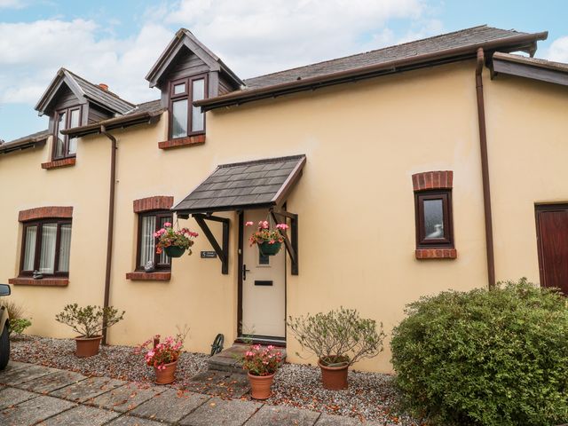 A front view of a cottage with planters at Ocean Cottage in Bude