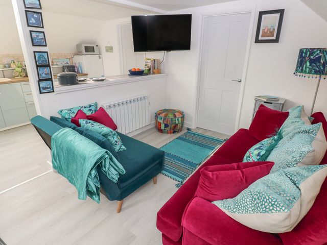 A living room with a sofa and television at Over the way Cosheston near Pembroke