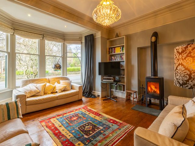 A living room with a sofa and fireplace at The Boundary in Windermere