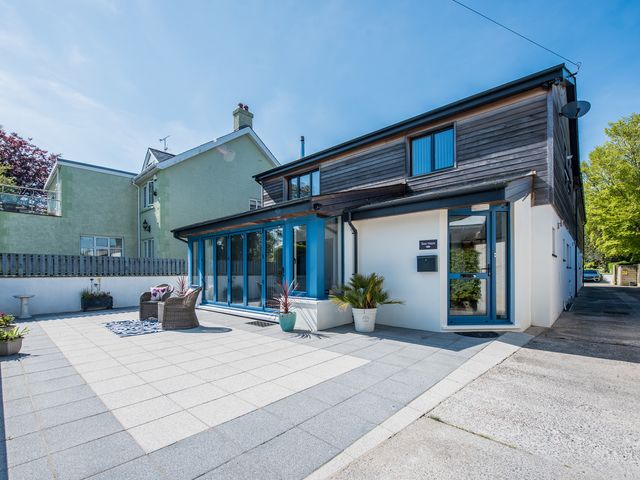 A house with patio and chairs at Sea Haze in Tenby