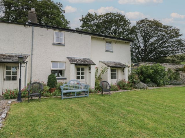 A house with benches and gardens at The Laundrymaid's Cottage in Cartmel