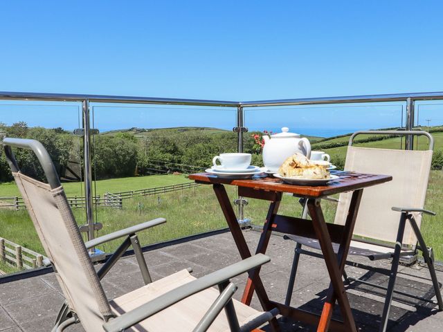 An outdoor table setting with tea and scones at Atlantic View (1 bed) in Bude