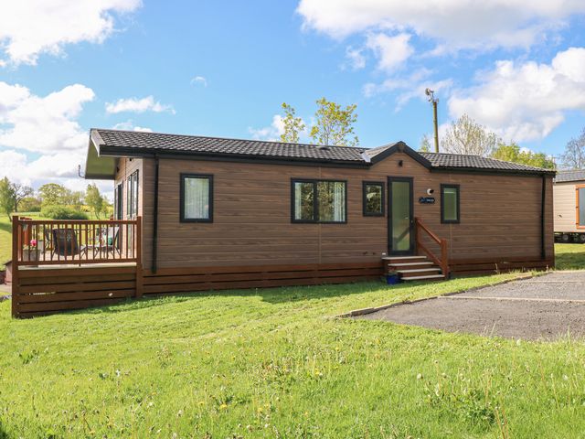 A mobile home with a deck and steps at Lodge 52 in Richmond