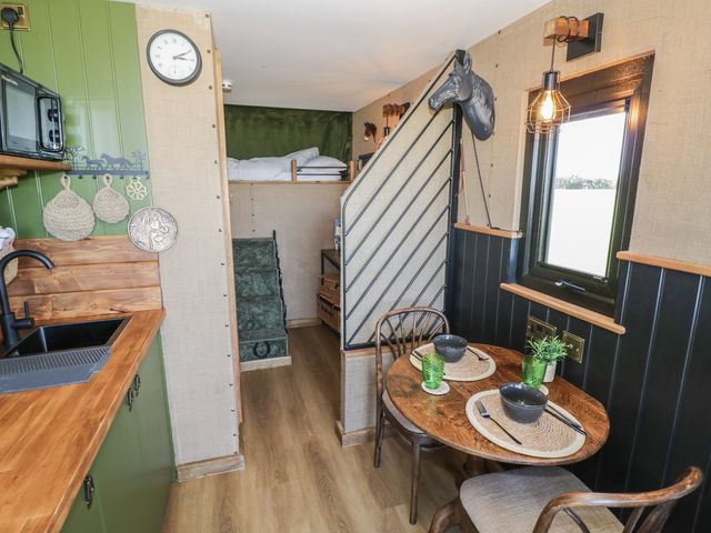 A kitchenette with dining table and chairs at GiGi's Horsebox Evesham
