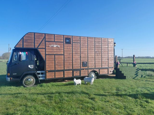 A horsebox parked on grass at GiGi's Horsebox Near Broadway