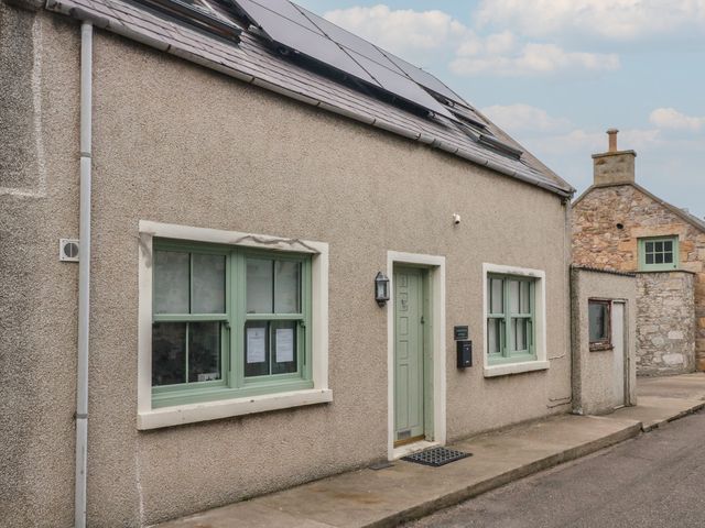 A building exterior with windows and a door at Portknockie Cottage in Portknockie