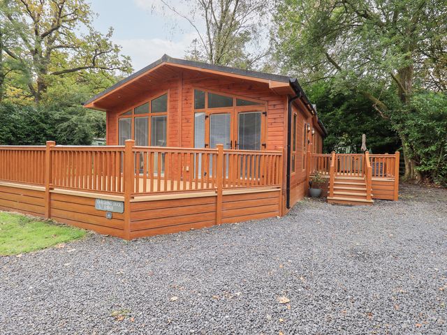 A lodge with decking and steps at Laughing Duck in Troutbeck Bridge
