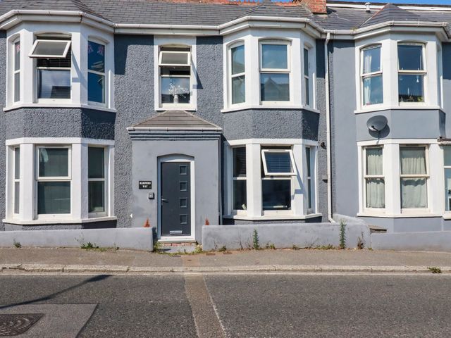A house with multiple windows and a front door at Higher Tower Road 