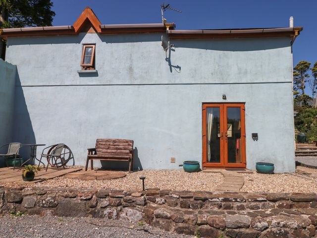 An outdoor area with a bench and table at Tor Cefn Annex in Kidwelly