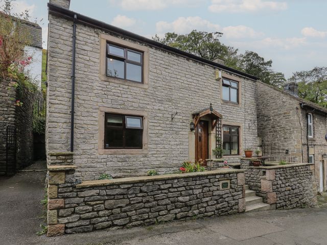A house with stone walls and a front door at Bradshaw House in Hope Valley