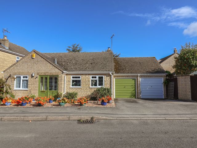 A bungalow with a green door and garages at Evergreen in Broadway