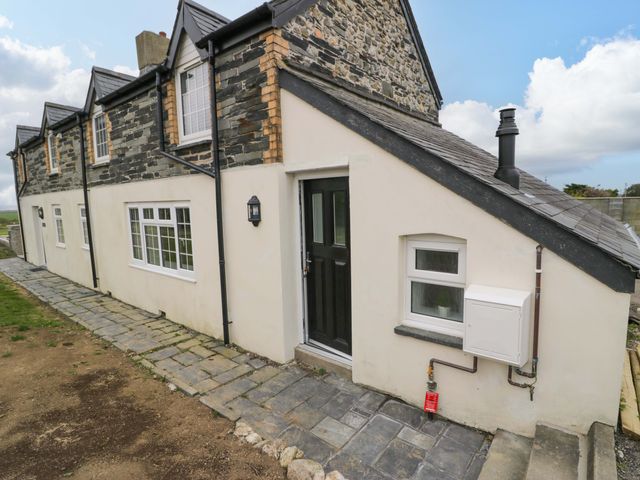 A house exterior with a door and window at Rosemary Cottage 1 Tywyn