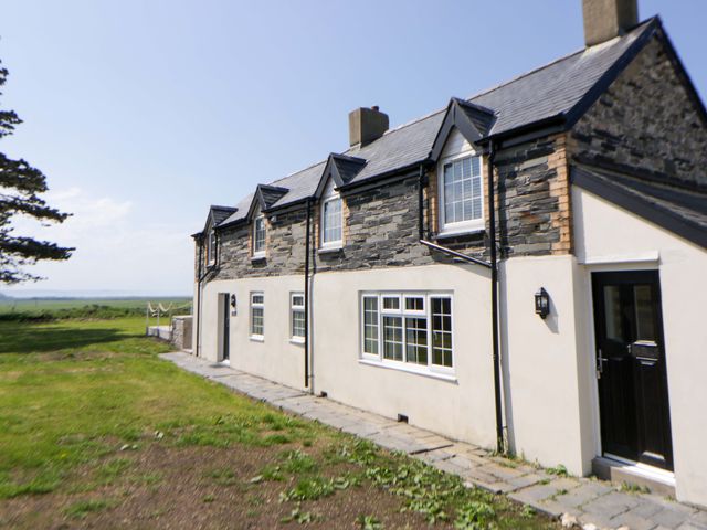 A house exterior with windows and a door at Rosemary Cottage 1 Tywyn