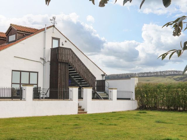 A building with a staircase and grassy area at 2 Jade side in Malton