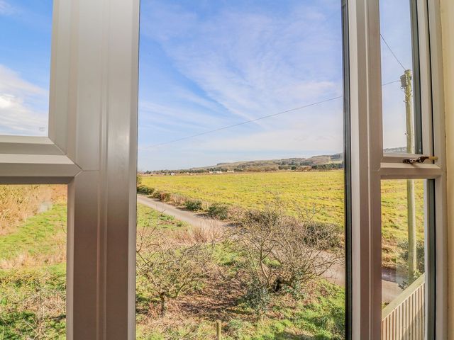 A view from a window overlooking a field and a road at 3 Marinas side Malton