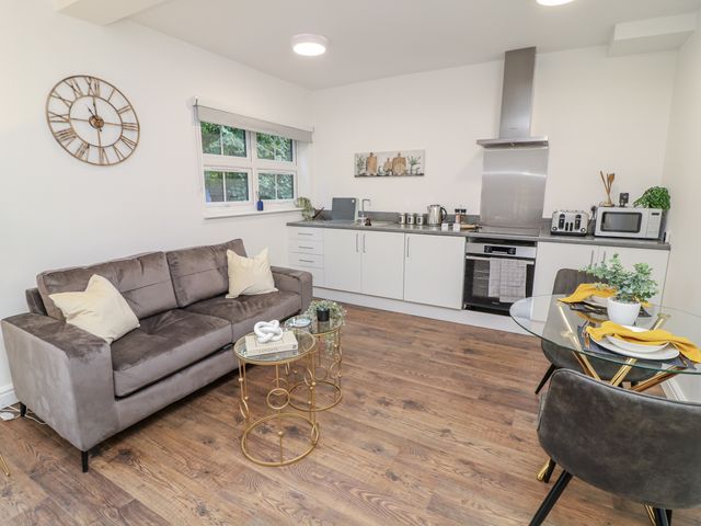 A kitchen with a sofa and dining area at 2 Peterborough