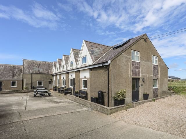 An outdoor area with a building and furniture at Rhiw - 1 Ty'n Don Abersoch