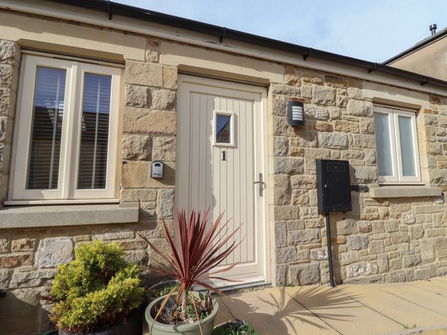 An entrance with a door and windows at Hideaway Cottage No 1 Seahouses