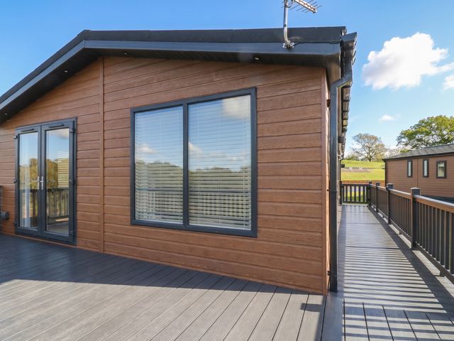 An outdoor area with a view of wooden decking and a hotel at Number 35