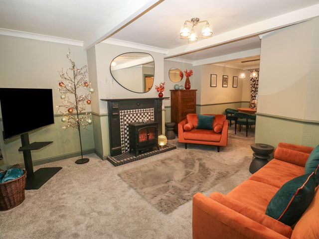 A living room with a fireplace and television at Franbols Cottage in Shelf