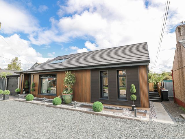 A house with windows and plants in the front yard at Scotia At The Brig Annan