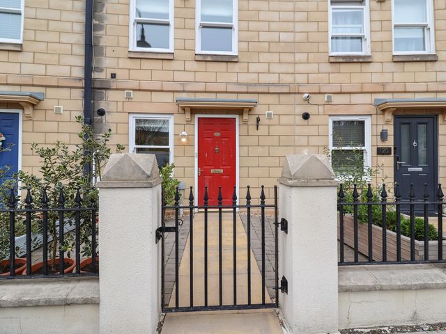 An outdoor area with three doors and plants at 122 Longridge Way Weston-Super-Mare