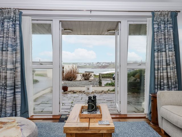 A living room with sliding doors and a view at 8 Thurlestone Rock in Kingsbridge