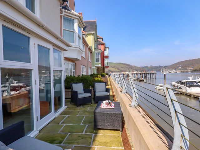 An outdoor area with seating and water view at 26 Dart Marina