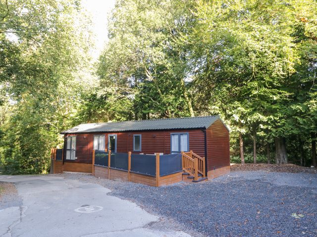 A lodge with a deck and steps at Feather Hill Lodge White Cross Bay near Troutbeck Bridge