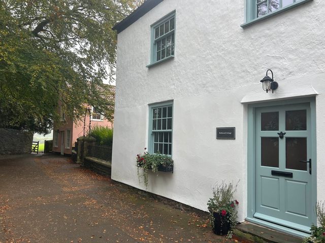 A house exterior with a door and windows at Redwood Cottage in Blagdon