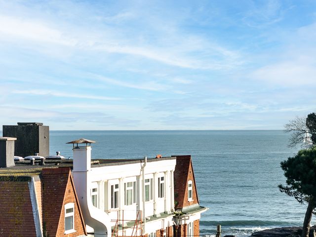 A view of a building and ocean at The Renior Sea View Suite Torquay
