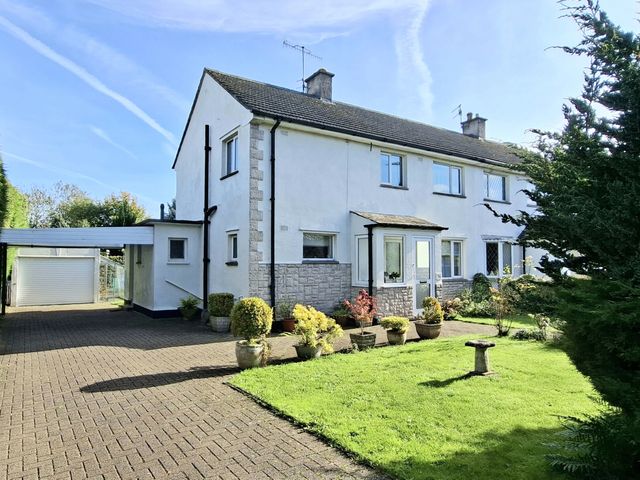 A house with a carport and garden at Apple Byrd in Kendal