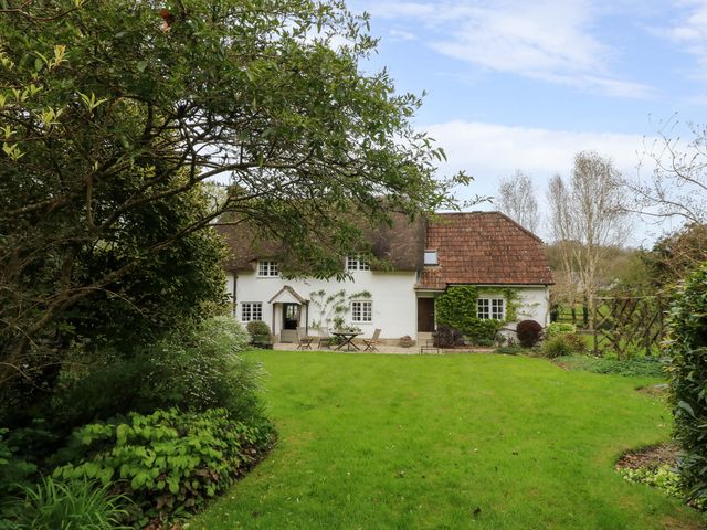 A house with a garden and patio at Plush Cottage in Plush